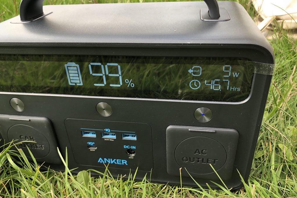Anker PowerHouse II 400 portable battery at 99% charge on grass.