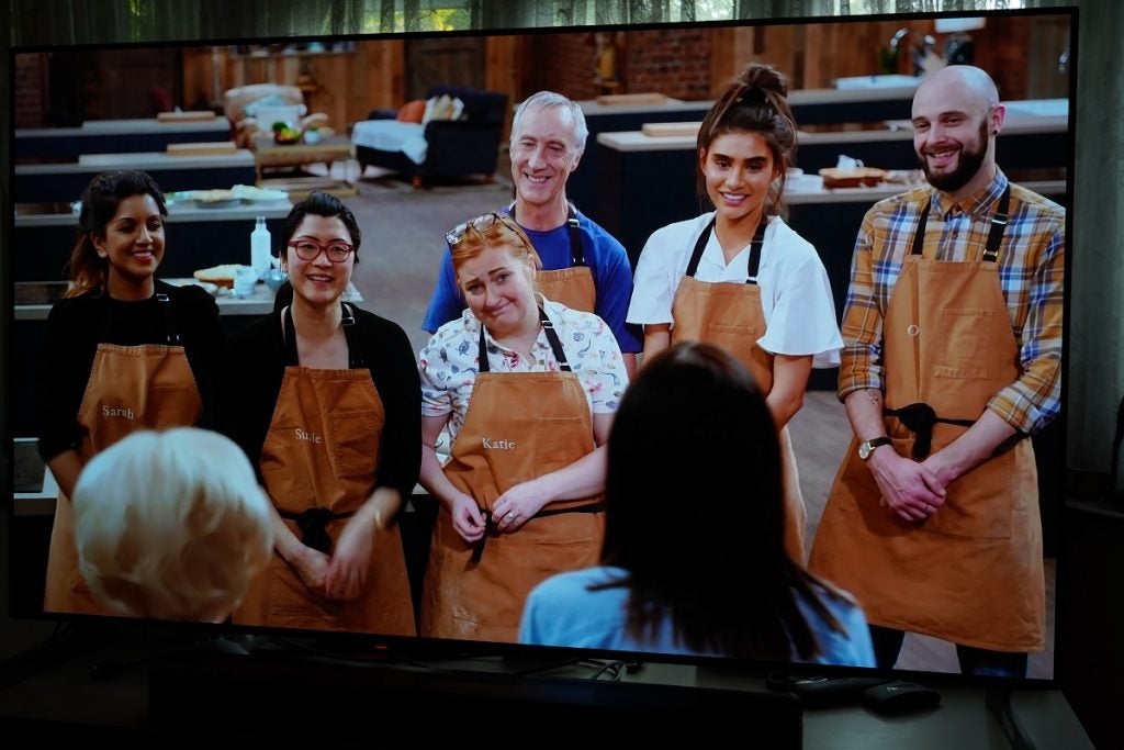 LG G1 OLED TV playing a TV show, displaying a few people standing wearing apron