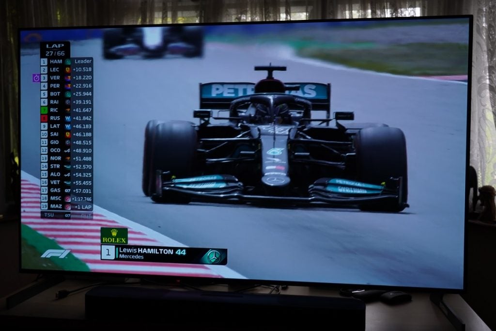 LG G1 OLED TV displaying F1 racing with a list of racers on the left 