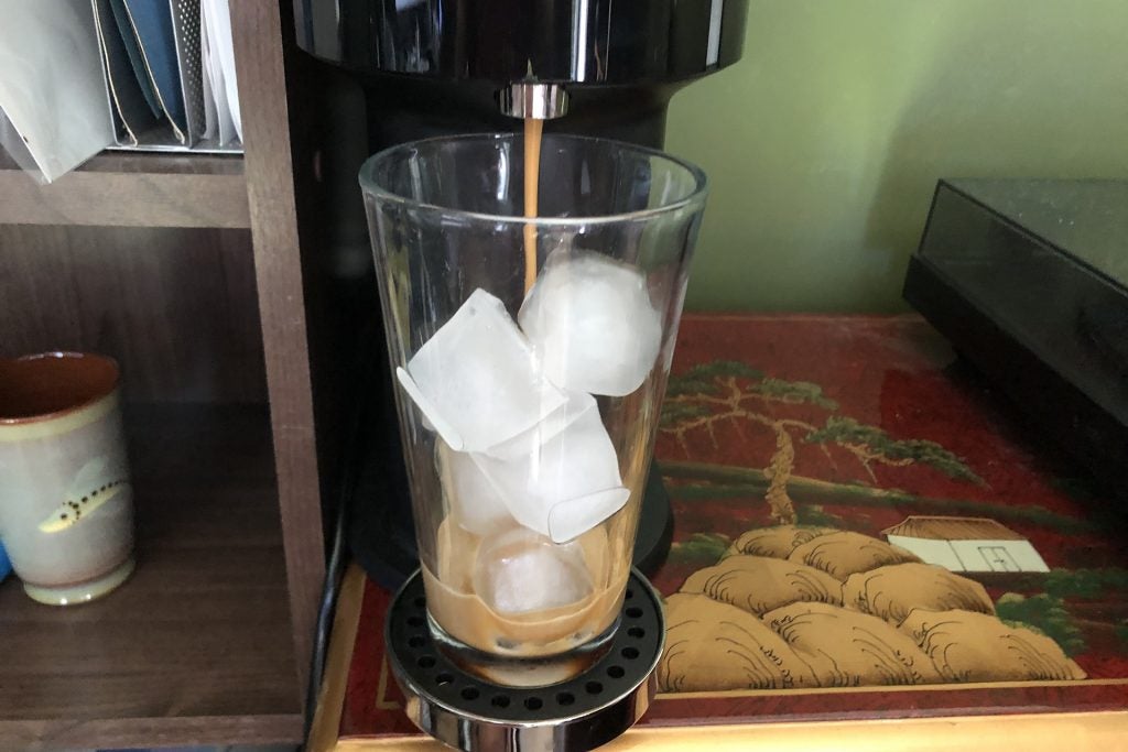 Nespresso Vertuo pouring coffee into a glass of ice