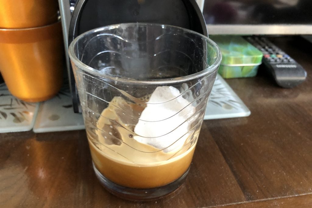 An espresso poured over ice from a Nespresso machine