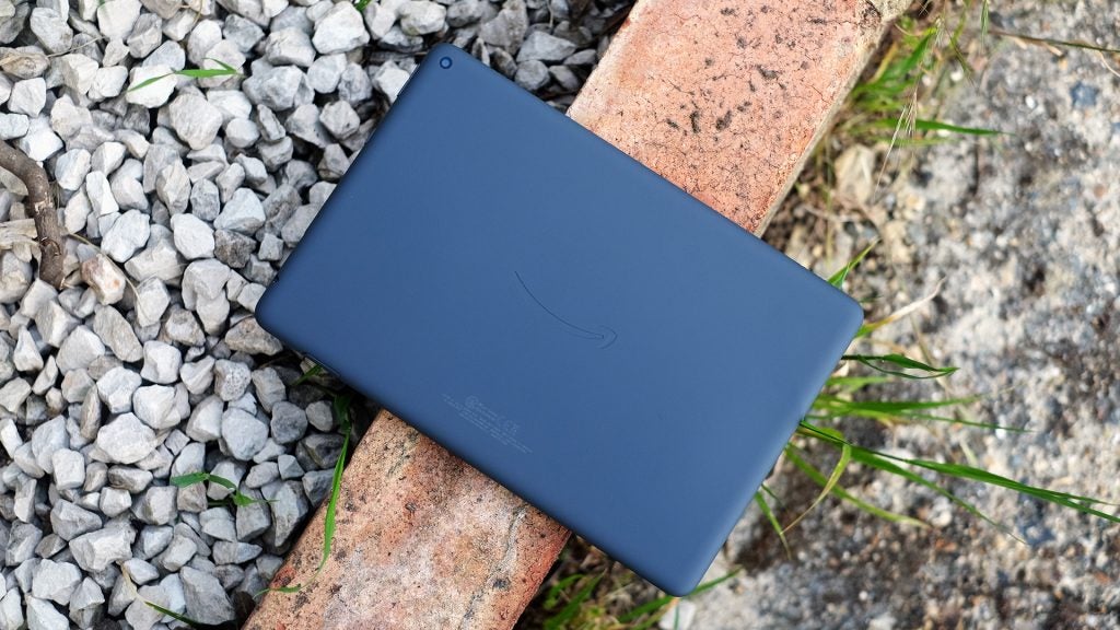 The back of the Amazon Fire HD 10 PlusTop back side view of a blue Fire HD 10 plus tablet resting upside down on top of a wall