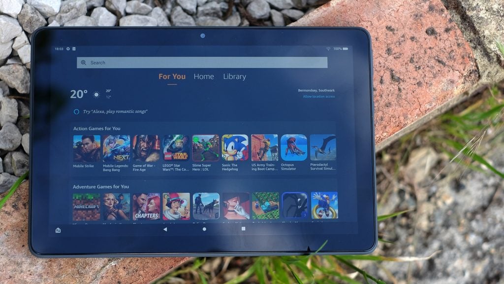Amazon Fire HD 10 Plus in the sunshine showing a very glary screenFront view of a blue Fire HD 10 plus tablet with visible For you screen and games on it