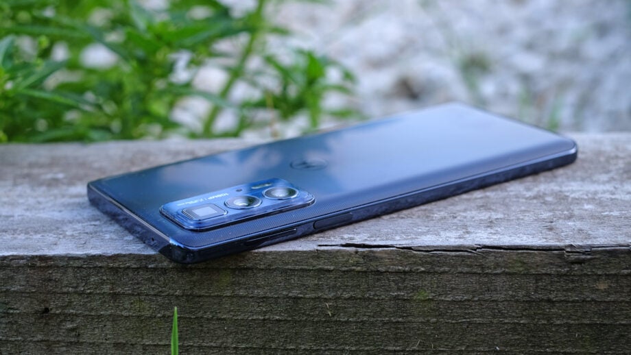 Motorola Edge 20 Pro smartphone on wooden surface.
