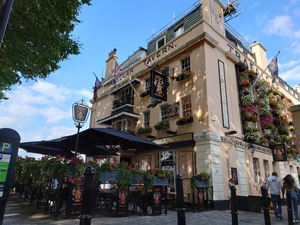 Exterior of a picturesque pub with floral decorations.