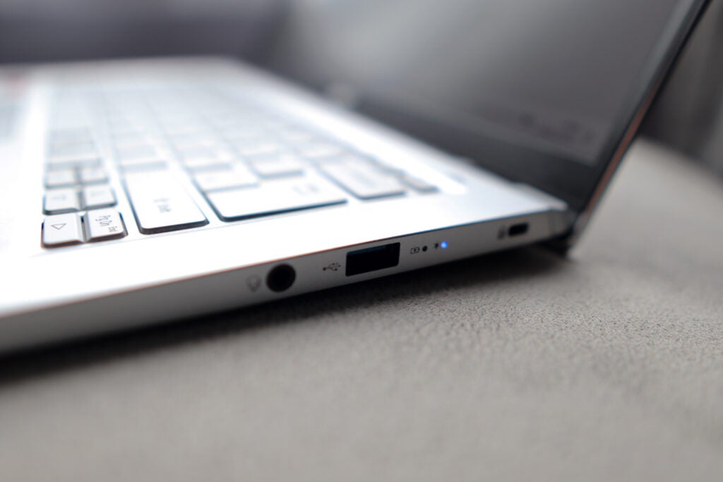 Laptop's right edge, showing headphone jack and USB-A.