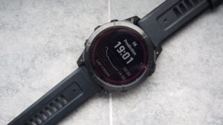 Garmin Fenix 7 watch displaying 5K running prediction time.