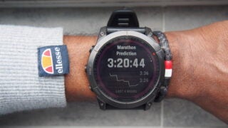 Garmin Fenix 7X on wrist showing marathon prediction feature.