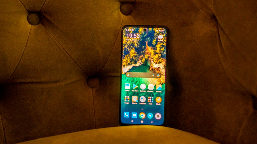Poco M4 Pro 5G screen, with the backdrop of upholstered furniture