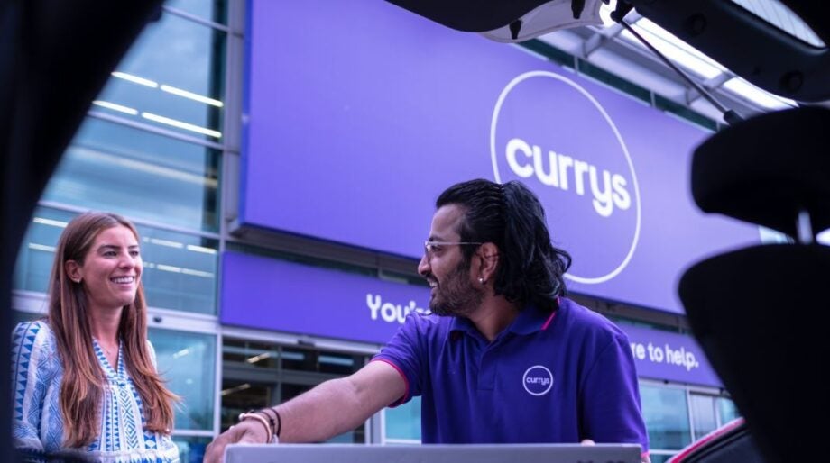 Currys employee taking something out of a car