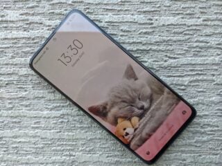 Poco X4 Pro 5G smartphone displaying a wallpaper with a sleeping kitten.