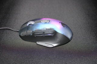 Roccat Kone XP gaming mouse with RGB lighting on fabric surface.