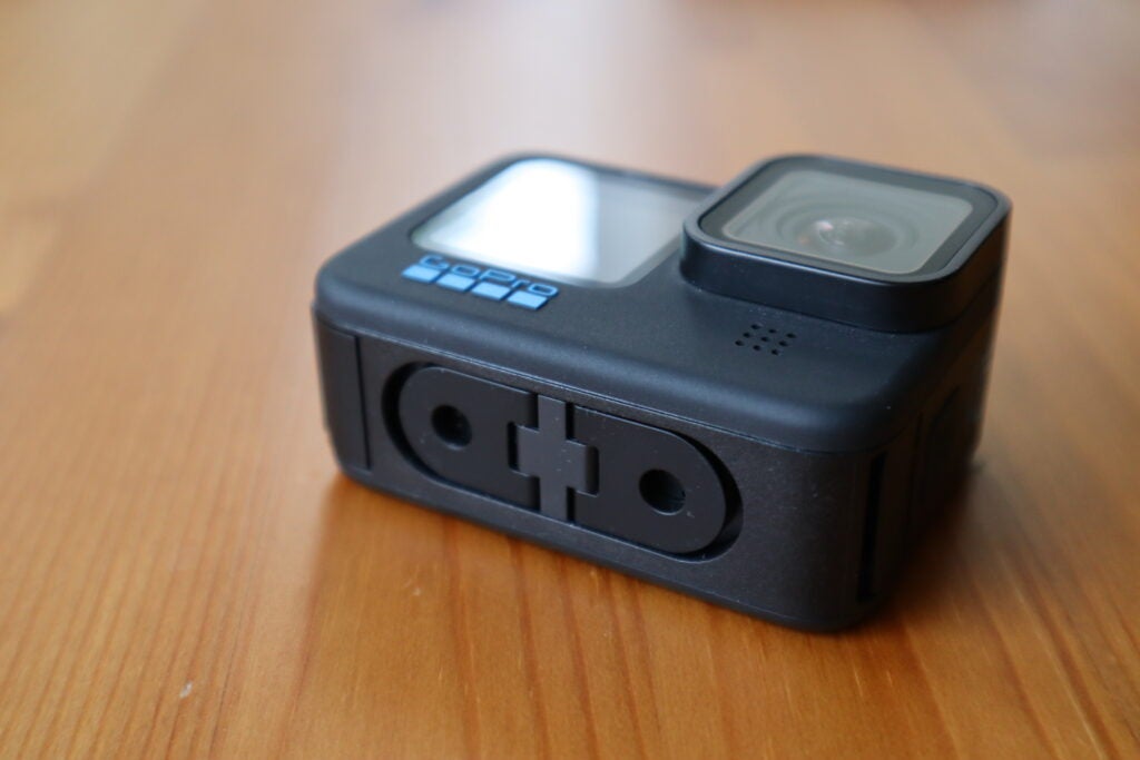 The underside of the GoPro Hero 10 Black, with the folding legs used for accessories
