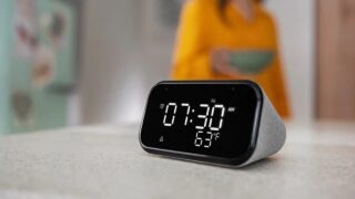 The Lenovo Smart Clock Essential in a press shoot on a desk