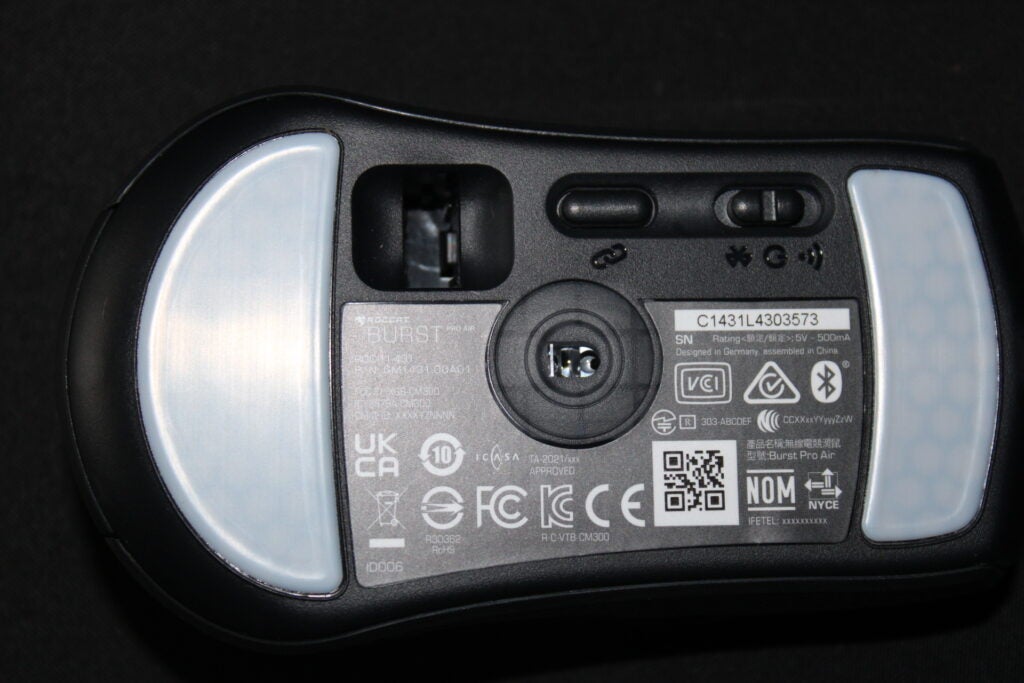 Close-up of Roccat Burst Pro Air gaming mouse underside with labels and QR code.