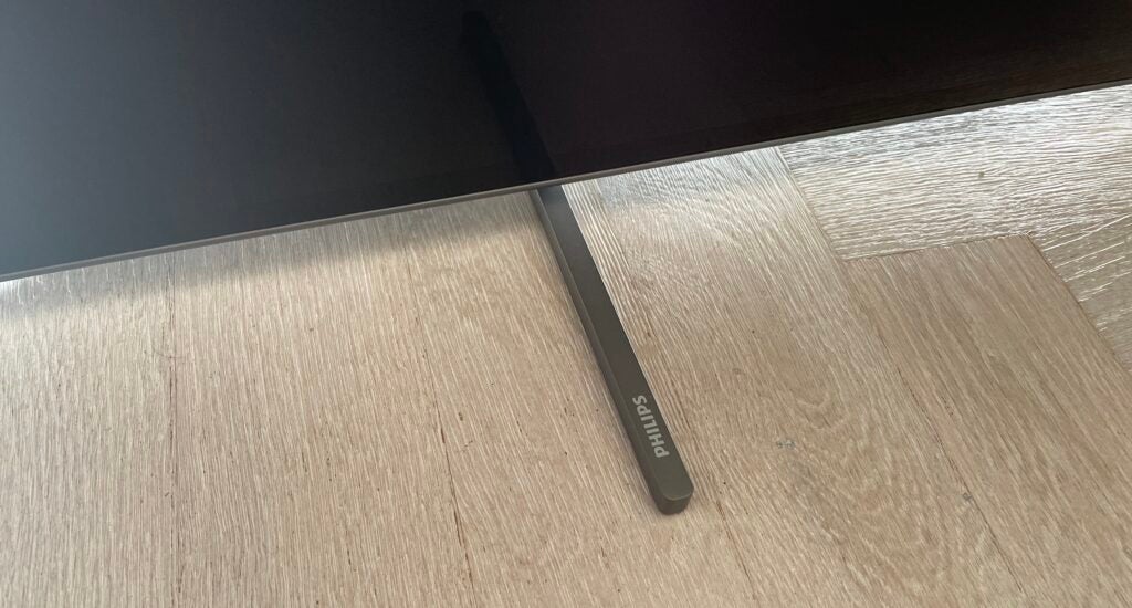 One support foot of the 55OLED806 TV, complete with Philips logo.