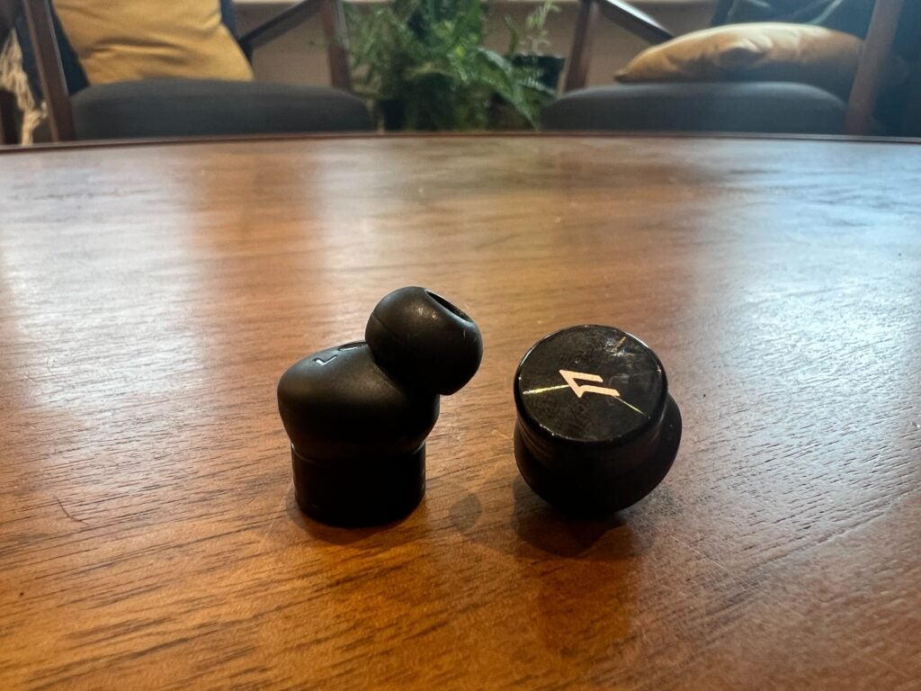 The PistonBuds Pro earbuds on the table on thier own