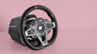 Thrustmaster T248 racing wheel against a pink background.