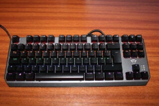 Trust Gaming GXT 834 Callaz keyboard on wooden desk.