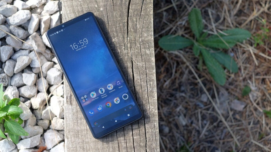Sony Xperia 10 IV smartphone on a wooden plank outdoors.
