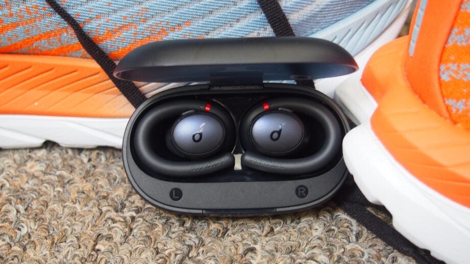 Soundcore X10 Sport next to trainers