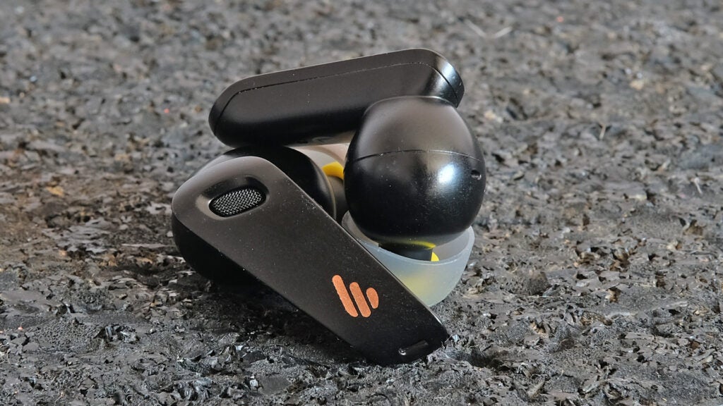 Edifier NeoBuds S earbuds with charging case on textured surface.