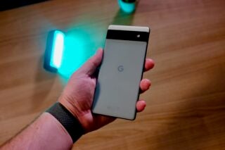 Holding the the back of the Pixel 6a in Sage