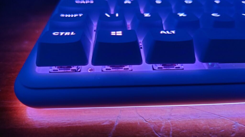 Close-up of Logitech G715 keyboard with purple backlight.