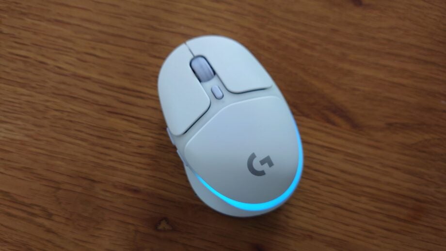 Logitech G705 wireless mouse on a wooden surface.