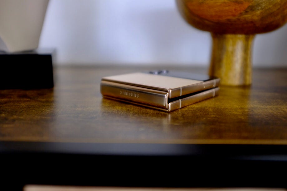 Samsung Galaxy Z Flip 4 folded on a wooden table.