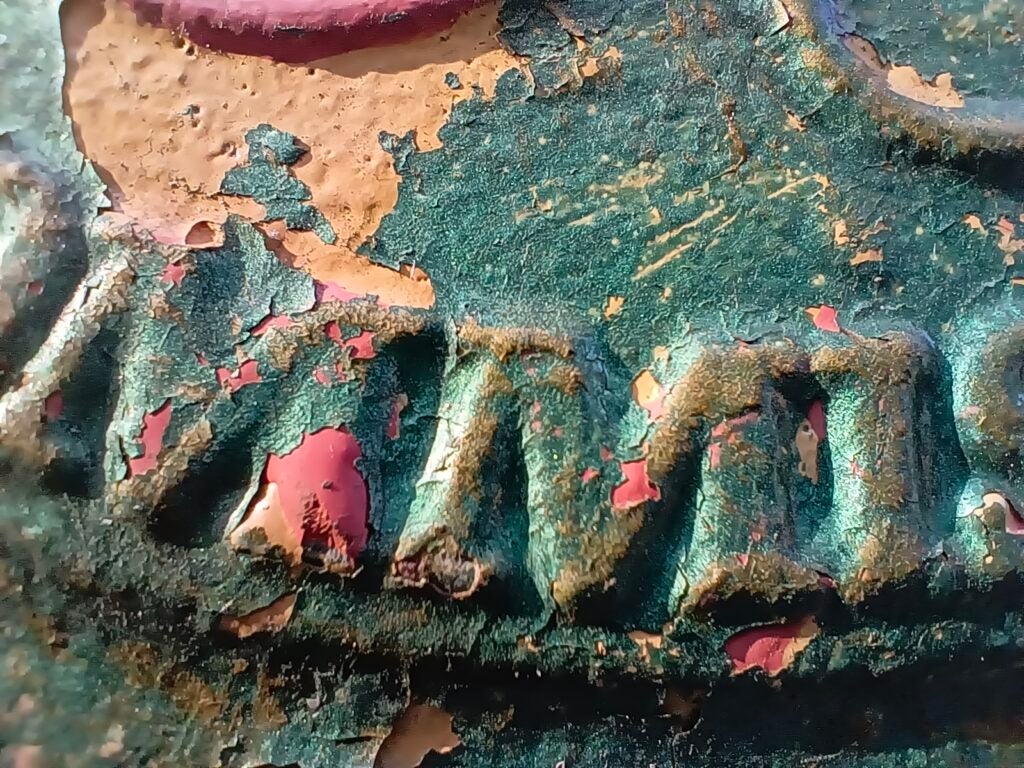 Close-up of peeling paint texture on metal surface.