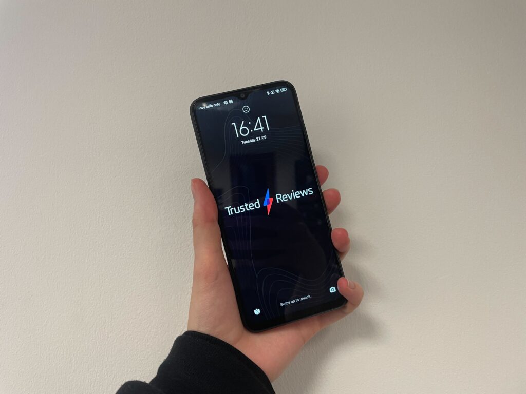The Poco M5 being held in my hand