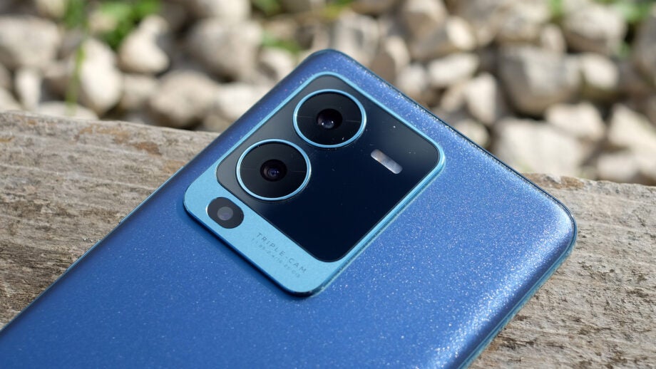Vivo V25 Pro smartphone camera close-up on wooden surface.