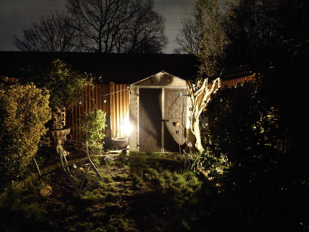 Night photo of a shed in a garden taken with Xperia 5 IV.Night photo of a garden shed with ambient lighting