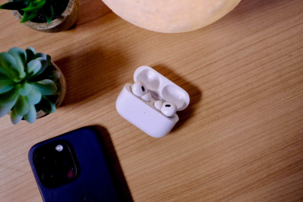 AirPods Pro on a table next to an iPhone