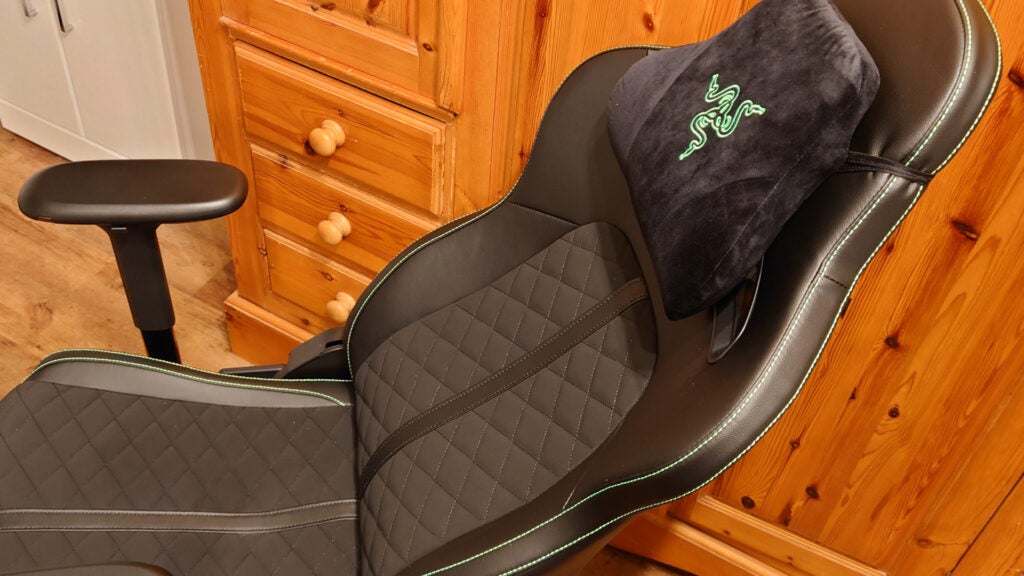 The Razer chair leaning back, with headrest pillow in view
