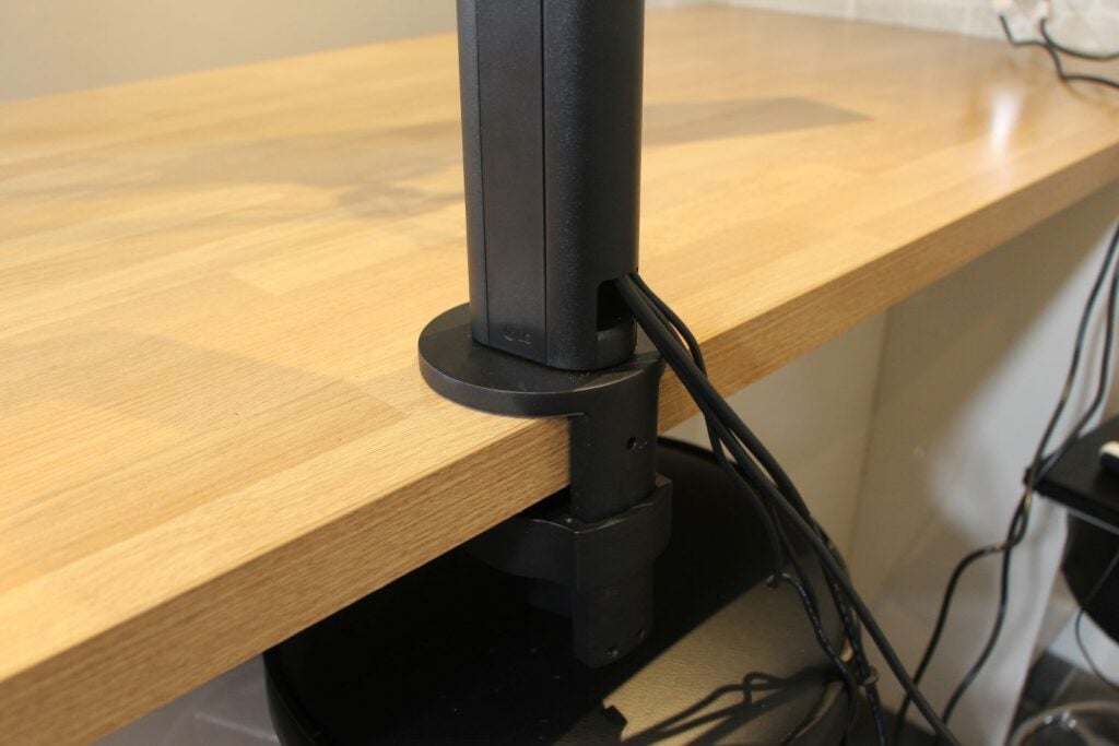 The LG Ergo Dual 27QP88D's clamp attached to a desk