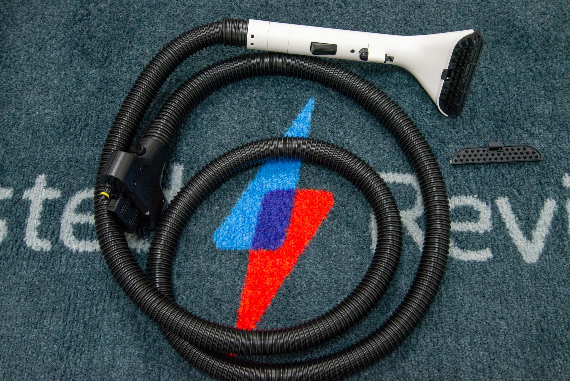 The Tineco Carpet One Pro's hose and detail brush