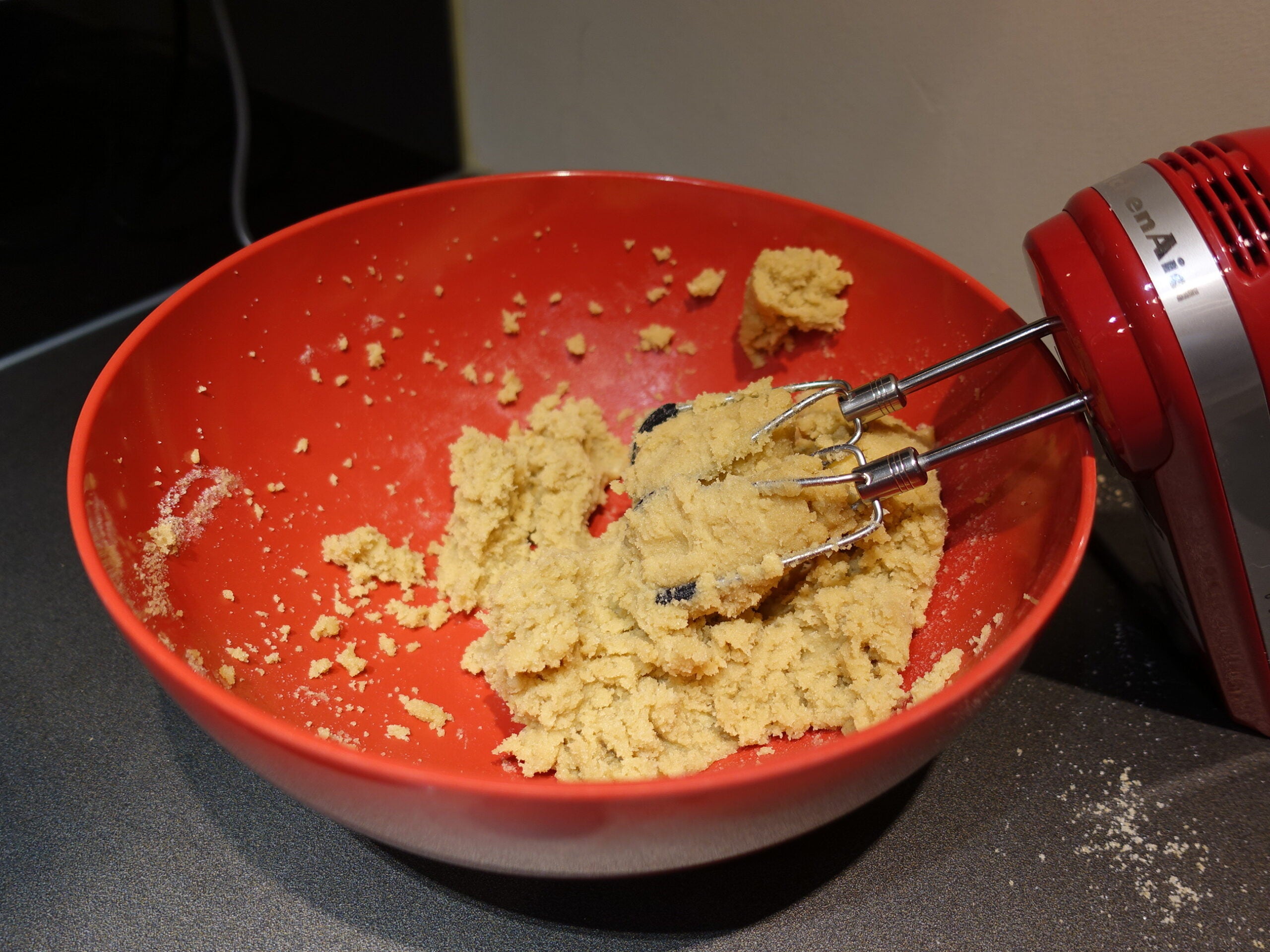 KitchenAid 6 Speed Hand Mixer with Flex Edge Beaters mixing dough