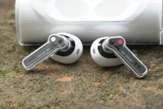 Nothing Ear (stick) earbuds with distinctive transparent stems.