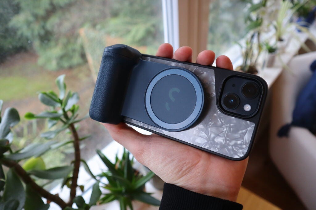 The ShiftCam SnapGrip attached to an iPhone 14