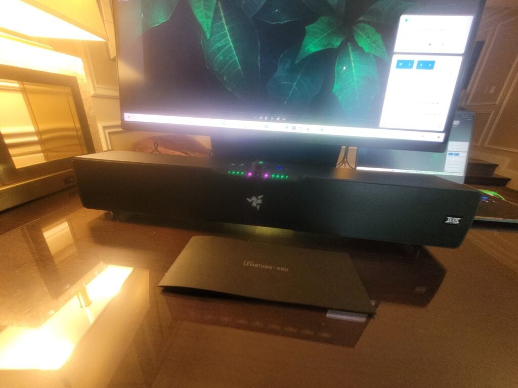 The Razer Leviathan V2 Pro sitting underneath monitor.