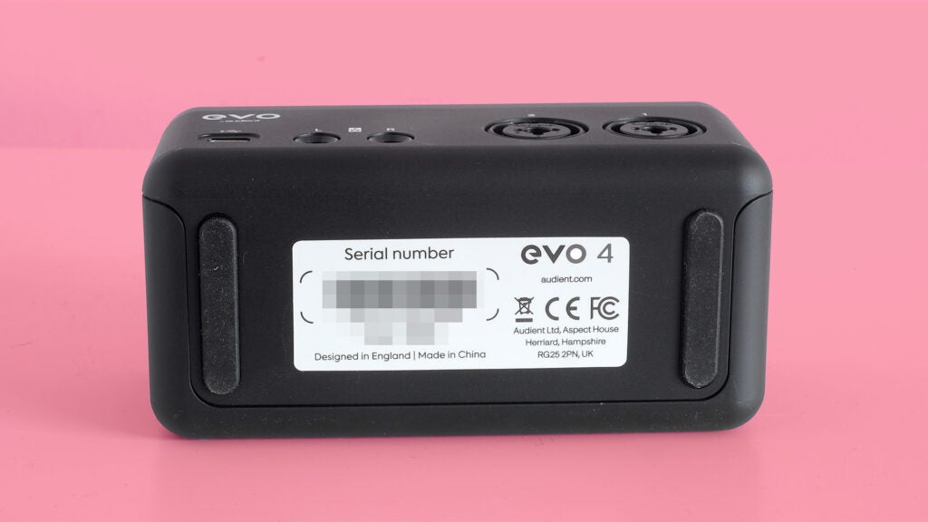 Audient Evo 4 audio interface on a pink background.