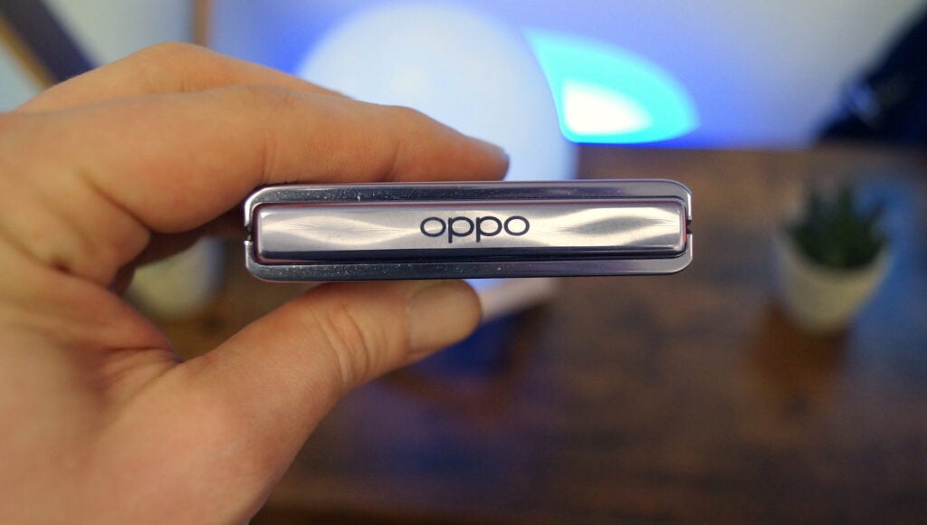 Close-up of Oppo logo on a smartphone hinge.