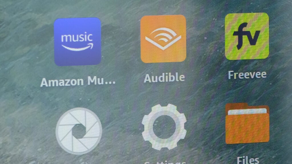 Amazon Fire HD 8 Plus tablet displaying app icons on screen.
