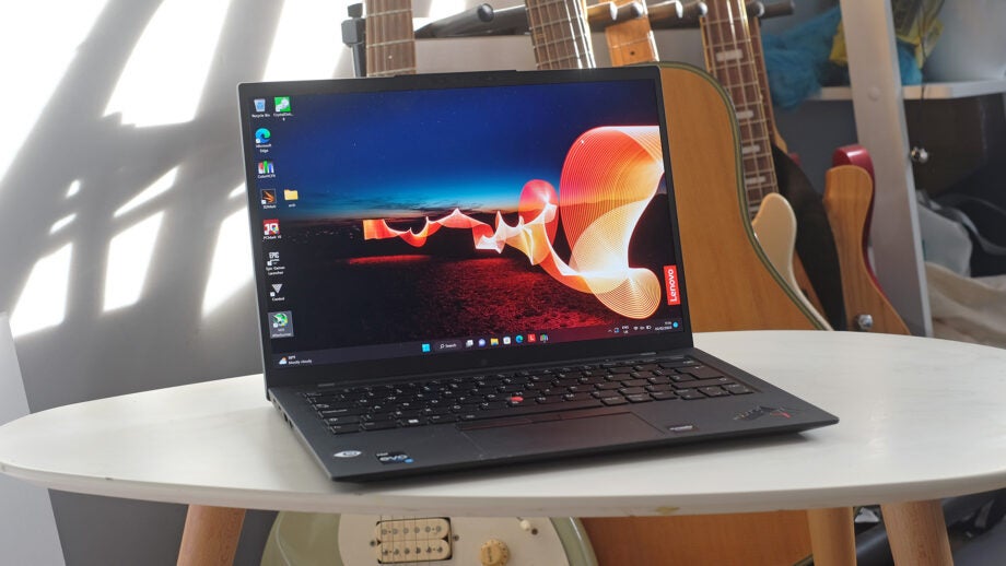 Lenovo ThinkPad X1 Carbon Gen 10 on white table with guitars in background.