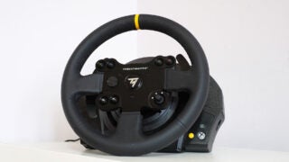 Thrustmaster TX racing wheel with leather grip and controls.