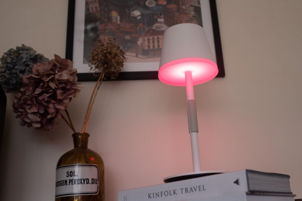 Hue Go Table Lamp with a red light on angled