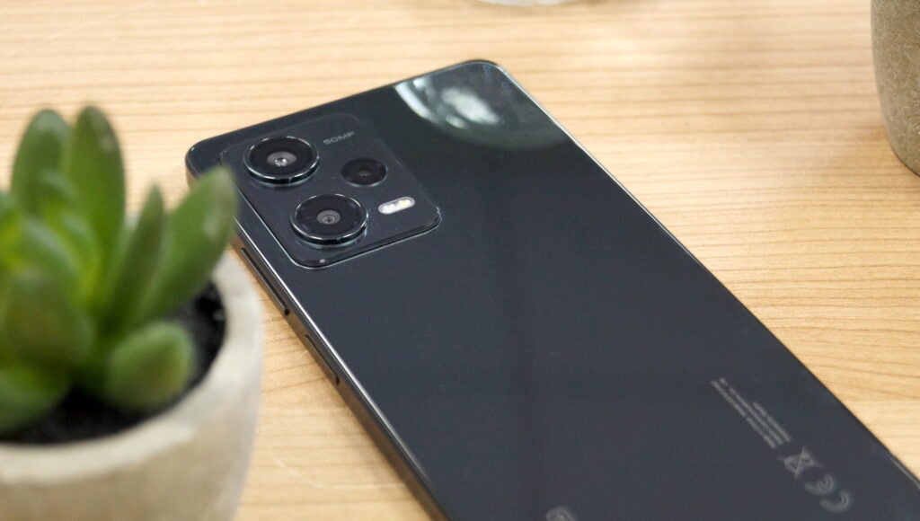 Redmi Note 12 Pro 5G on a table with a plant