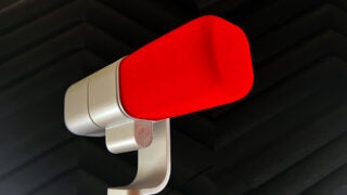 Close-up of Logitech Blue Sona microphone with red windscreen.